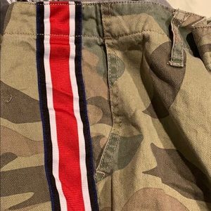 Green camo pants with red and blue stripe